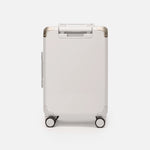 Beige hard shell carry-on suitcase, The Cabin Trunk Essential by Armoir, rear angle view